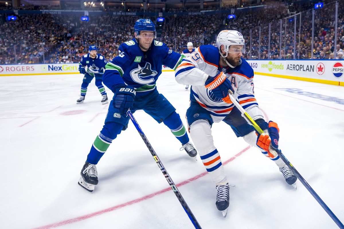 Then with Vancouver, Ilya Mikheyev (left) covers Edmonton star Leon Draisaitl in the 2024 playoffs