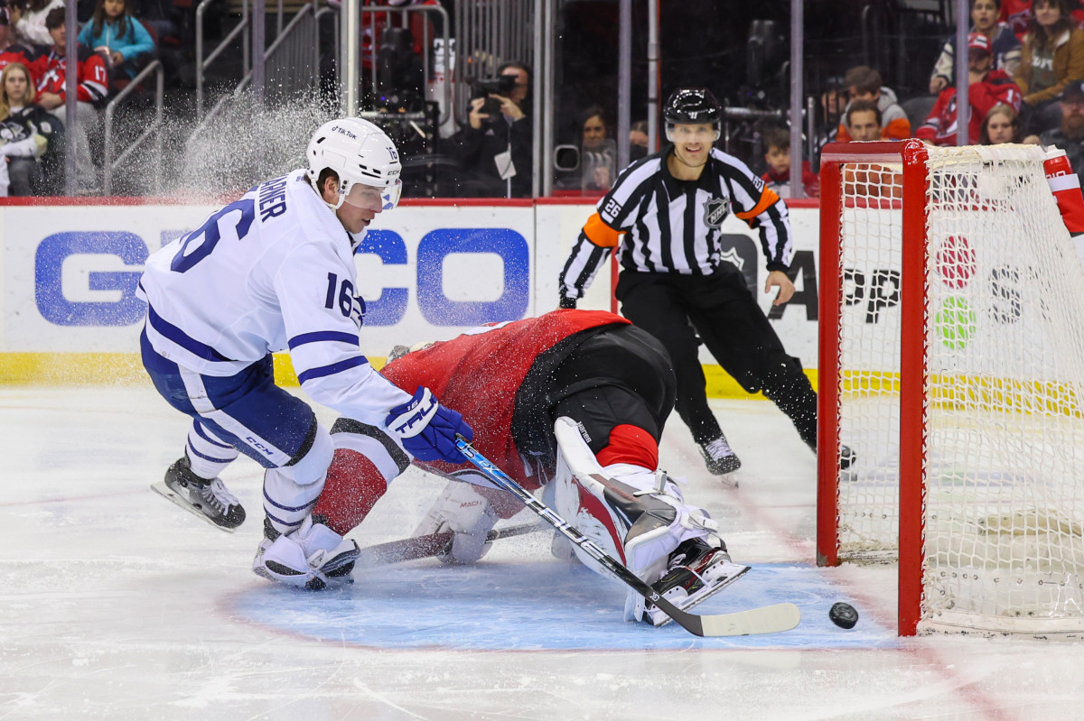 Mar 7, 2023; Newark, New Jersey, USA; Toronto Maple Leafs right wing Mitchell Marner (16) scores a goal on New Jersey Devils goaltender Vitek Vanecek (41) during the third period at Prudential Center. Mandatory Credit: Ed Mulholland-USA TODAY Sports