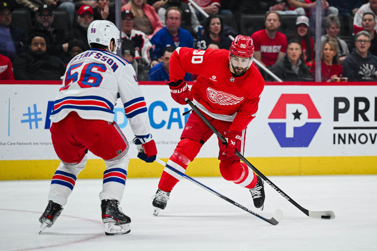 Apr 5, 2024; Detroit, Michigan, USA; Detroit Red Wings center Joe Veleno (90) shoots as New York Rangers defenseman Erik Gustafsson (56) defends during the game at Little Caesars Arena