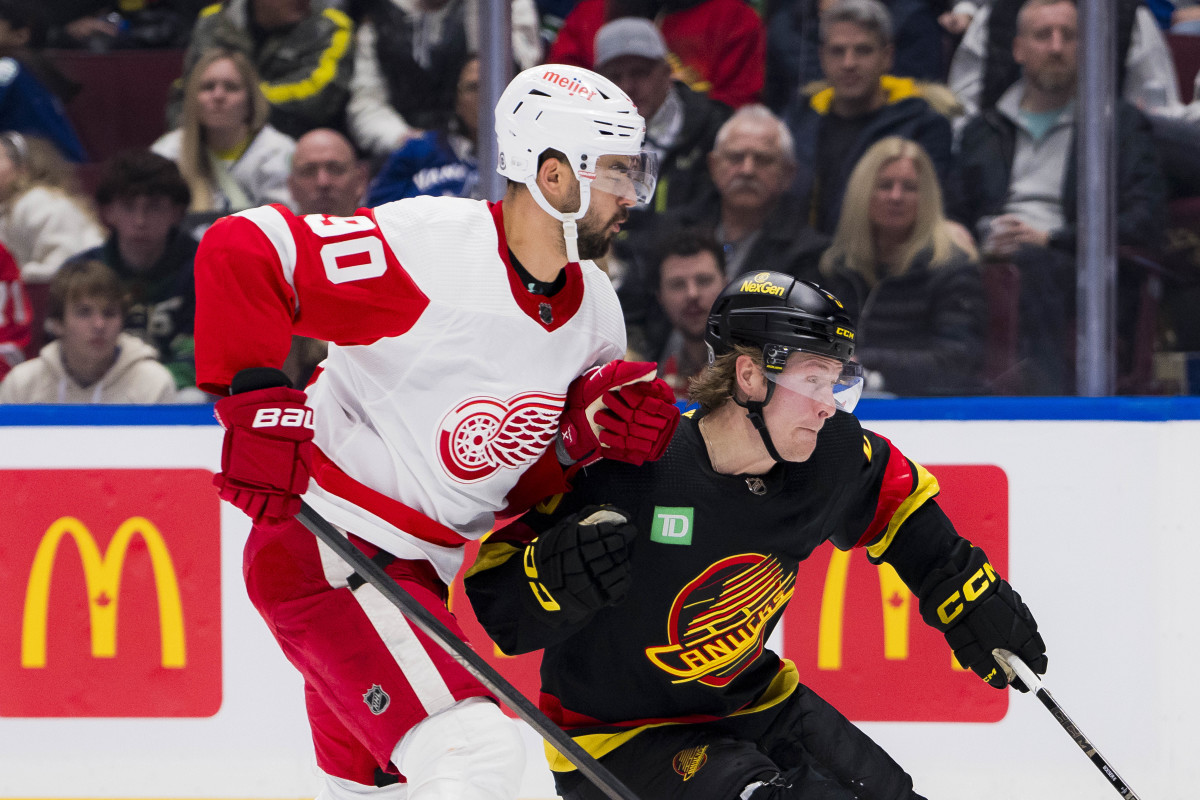 Feb 15, 2024; Vancouver, British Columbia, CAN; Detroit Red Wings forward Joe Veleno (90) battles with Vancouver Canucks forward Brock Boeser (6) in the third period at Rogers Arena