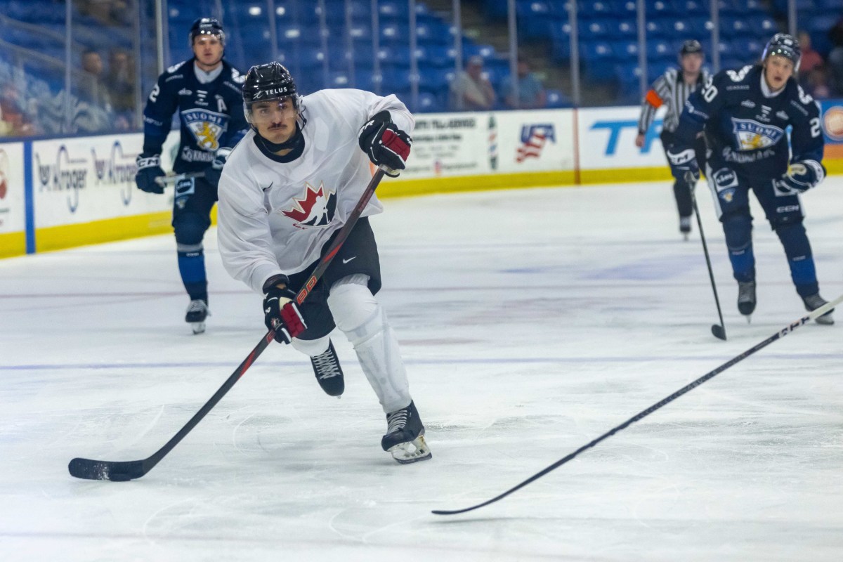 Canada's defenseman Andrew Gibson (8) shoots the puck against Finland