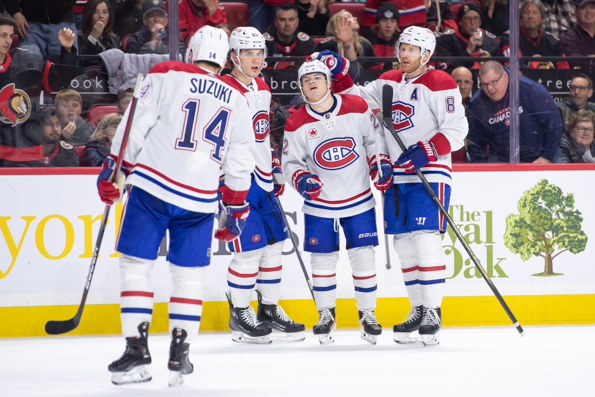 Apr 13, 2024; Ottawa, Ontario, CAN; Montreal Canadiens right wing Cole Caufield (22) celebrates with team his goal scored the second period against the Ottawa Senators at the Canadian Tire Centre. Mandatory Credit: Marc DesRosiers-Imagn Images