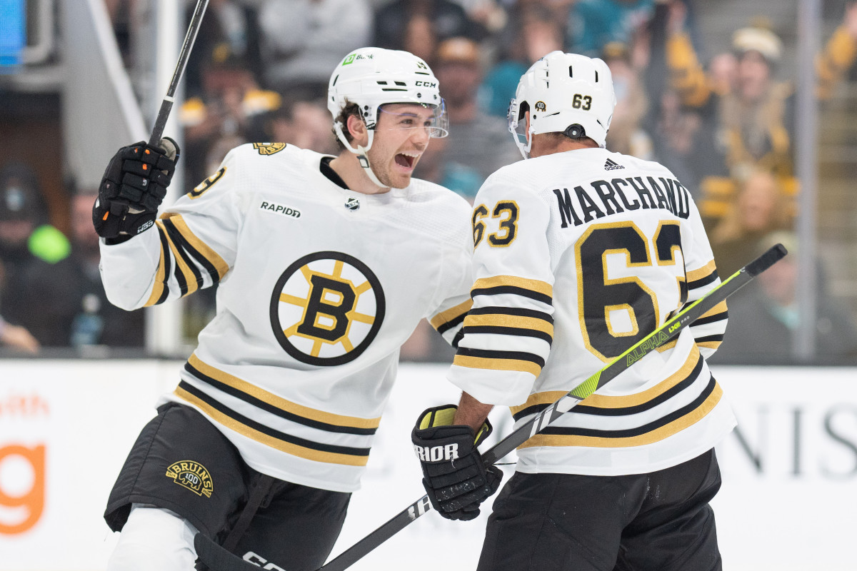 Oct 19, 2023; San Jose, California, USA; Boston Bruins center Johnny Beecher (19) celebrates with left wing Brad Marchand (63) during the first period against the San Jose Sharks at SAP Center at San Jose. Mandatory Credit: Stan Szeto-USA TODAY Sports