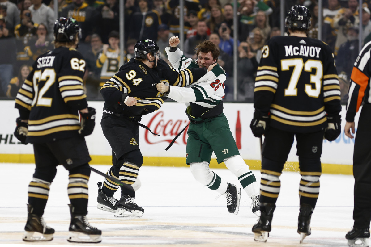 Dec 19, 2023; Boston, Massachusetts, USA; Boston Bruins center Jakub Lauko (94) fights with Minnesota Wild center Connor Dewar (26) during the first period at TD Garden. Mandatory Credit: Winslow Townson-USA TODAY Sports