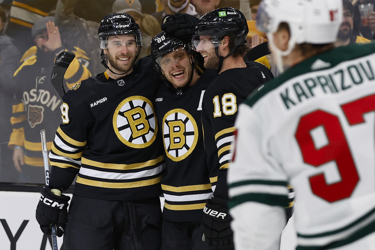 Dec 19, 2023; Boston, Massachusetts, USA; Boston Bruins right wing David Pastrnak (88) (center) is congratulated by defenseman Parker Wotherspoon (29) and center Pavel Zacha (18) after scoring his second goal against the Minnesota Wild during the first period at TD Garden. Mandatory Credit: Winslow Townson-USA TODAY Sports