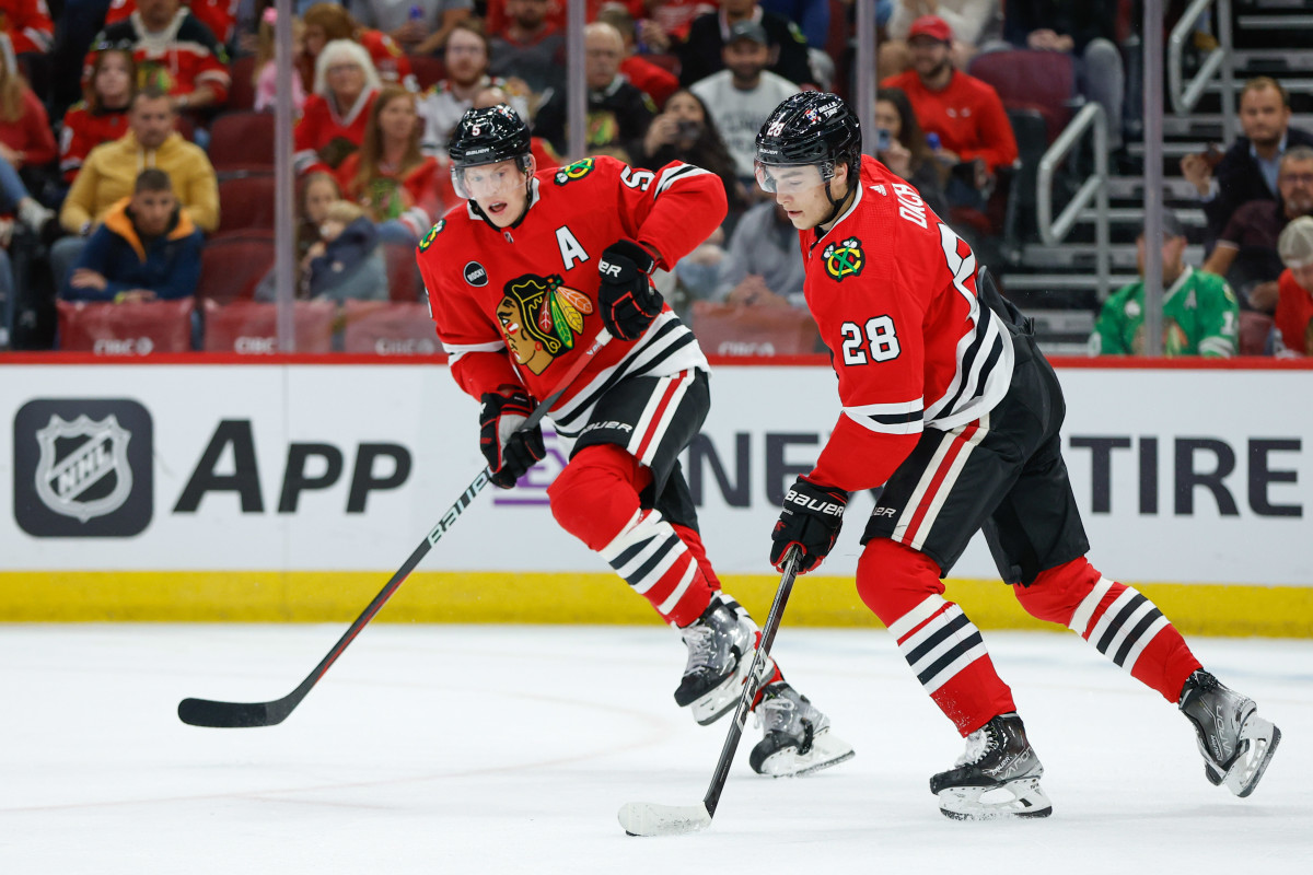 Oct 3, 2023; Chicago, Illinois, USA; Chicago Blackhawks center Colton Dach (28) controls the puck during the first period of a preseason hockey game against the Detroit Red Wings at United Center. Mandatory Credit: Kamil Krzaczynski-Imagn Images